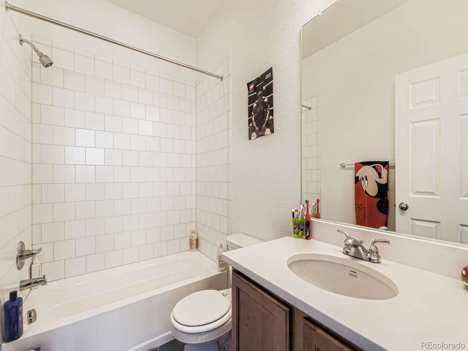 1680 South Tower Road Aurora, CO 80017 - Photo 24 of 26 a bathroom with a sink a toilet and bathtub