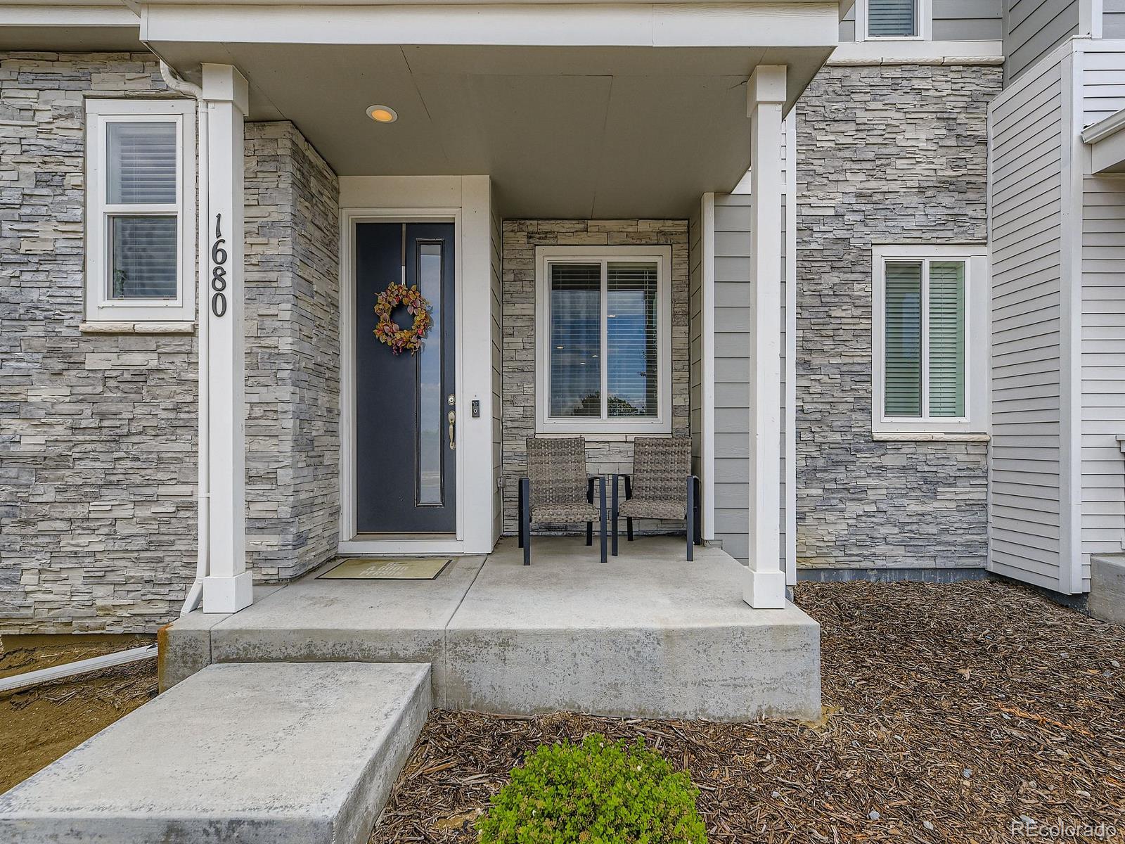 1680 South Tower Road Aurora, CO 80017 - Photo 4 of 26 a bench sitting in front of a house