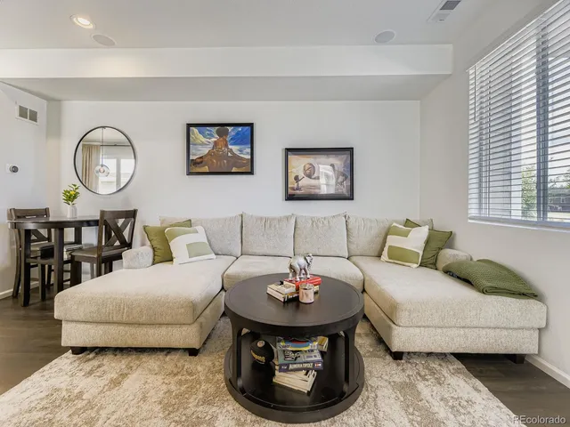 a living room with furniture and a wall