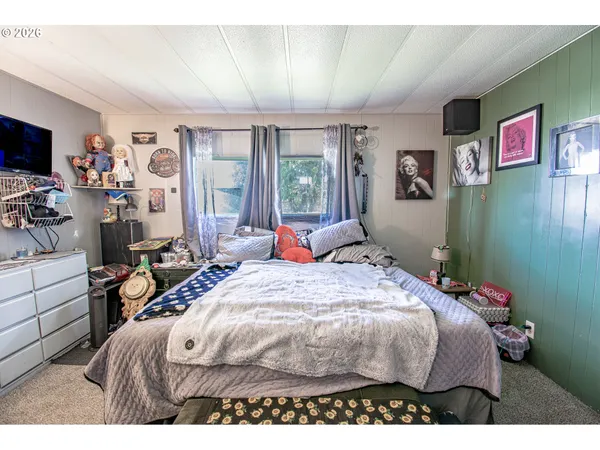 a bed sitting in a bedroom next to a window