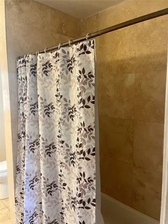 a bathroom with a shower curtain