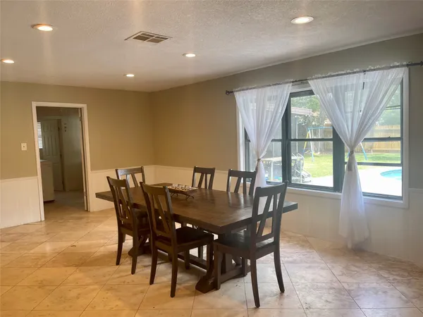 a view of a dining room with furniture and window