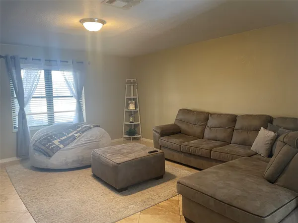 a living room with couches and painted walls