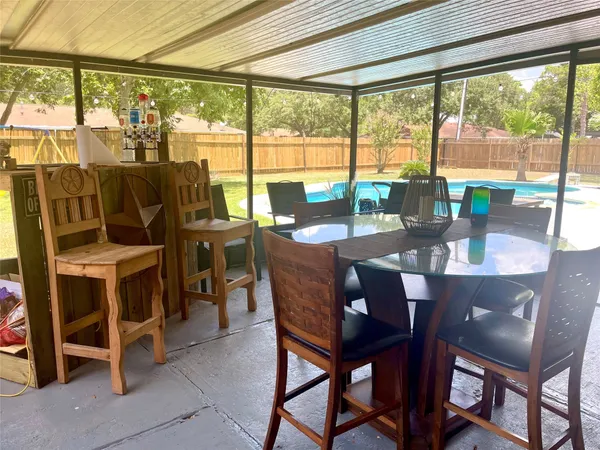 a dining room with furniture water view and a floor to ceiling window