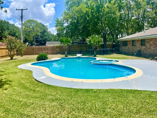 a view of a swimming pool with a yard
