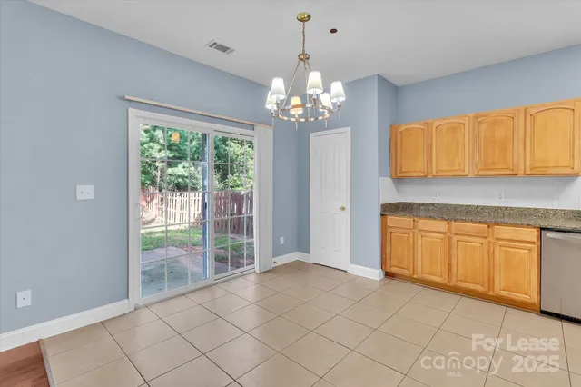 a view of a kitchen with dishwasher cabinet and a granite counter top