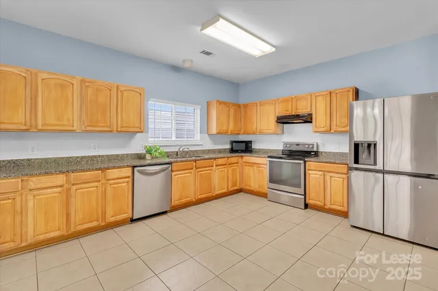 a kitchen with cabinets and white appliances