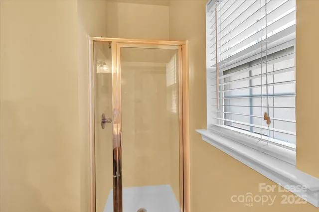 a view of a bathroom with a shower and a window
