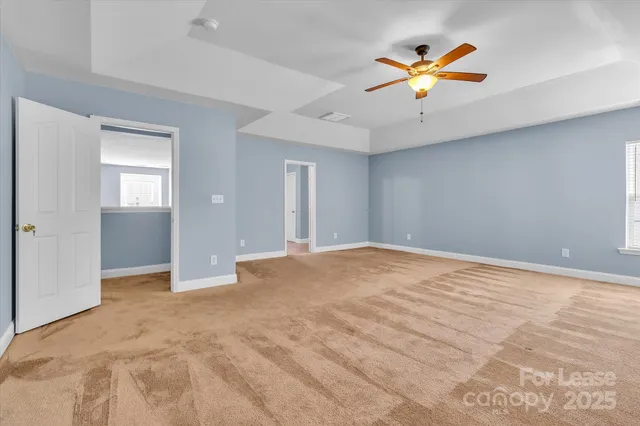 a view of a livingroom with a ceiling fan and window