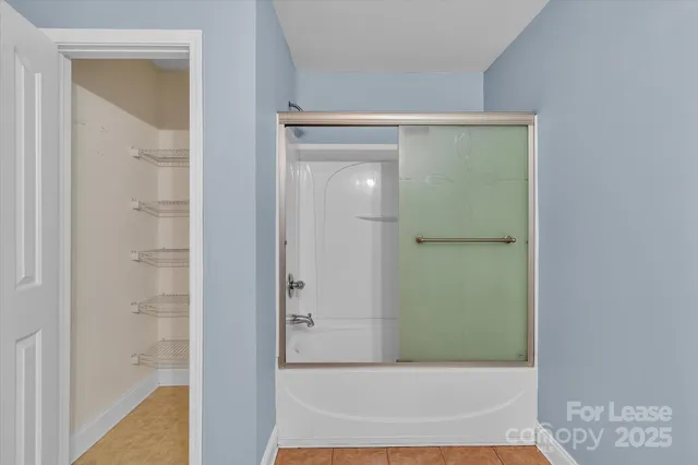 a bathroom with a bathtub and shower