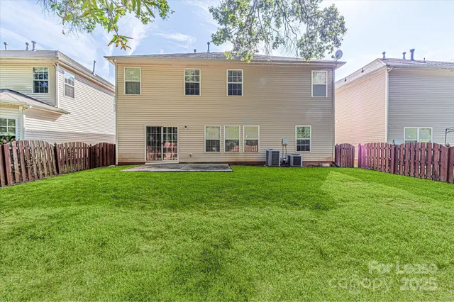 a view of house with backyard space and deck