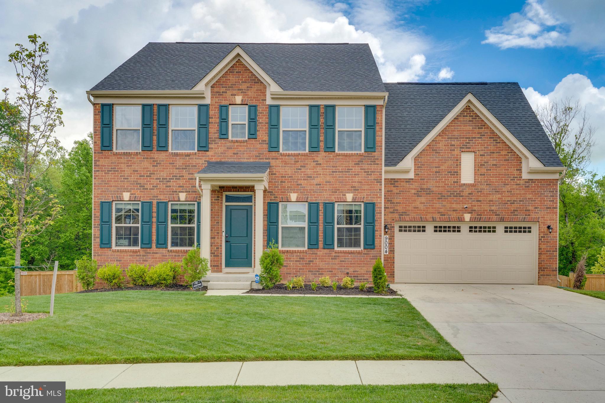 9004 Cavesson Way Upper Marlboro, MD 20772 - Photo 1 of 60 a front view of a house with a yard and garage