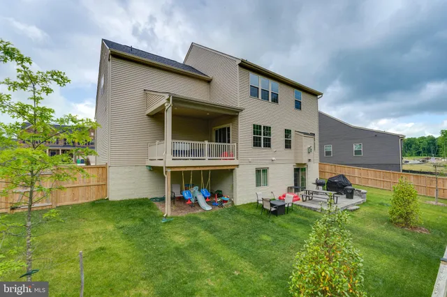 a view of a backyard with plants and a garden