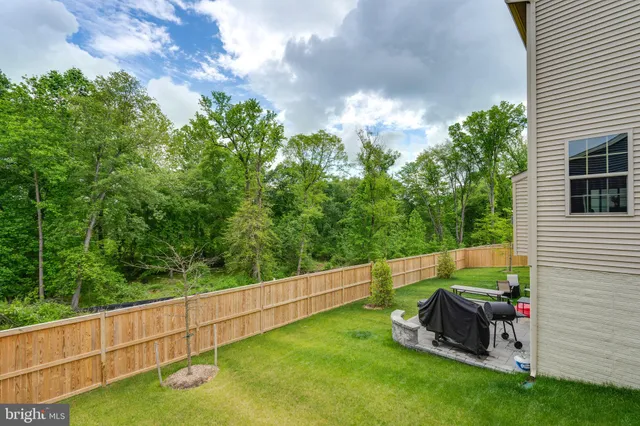 a view of a wooden chairs and table in the patio