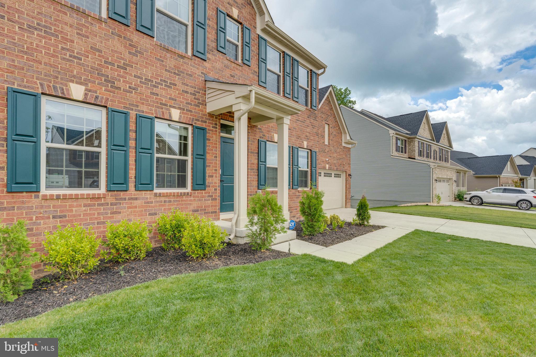 9004 Cavesson Way Upper Marlboro, MD 20772 - Photo 28 of 60 a view of a brick building next to a yard