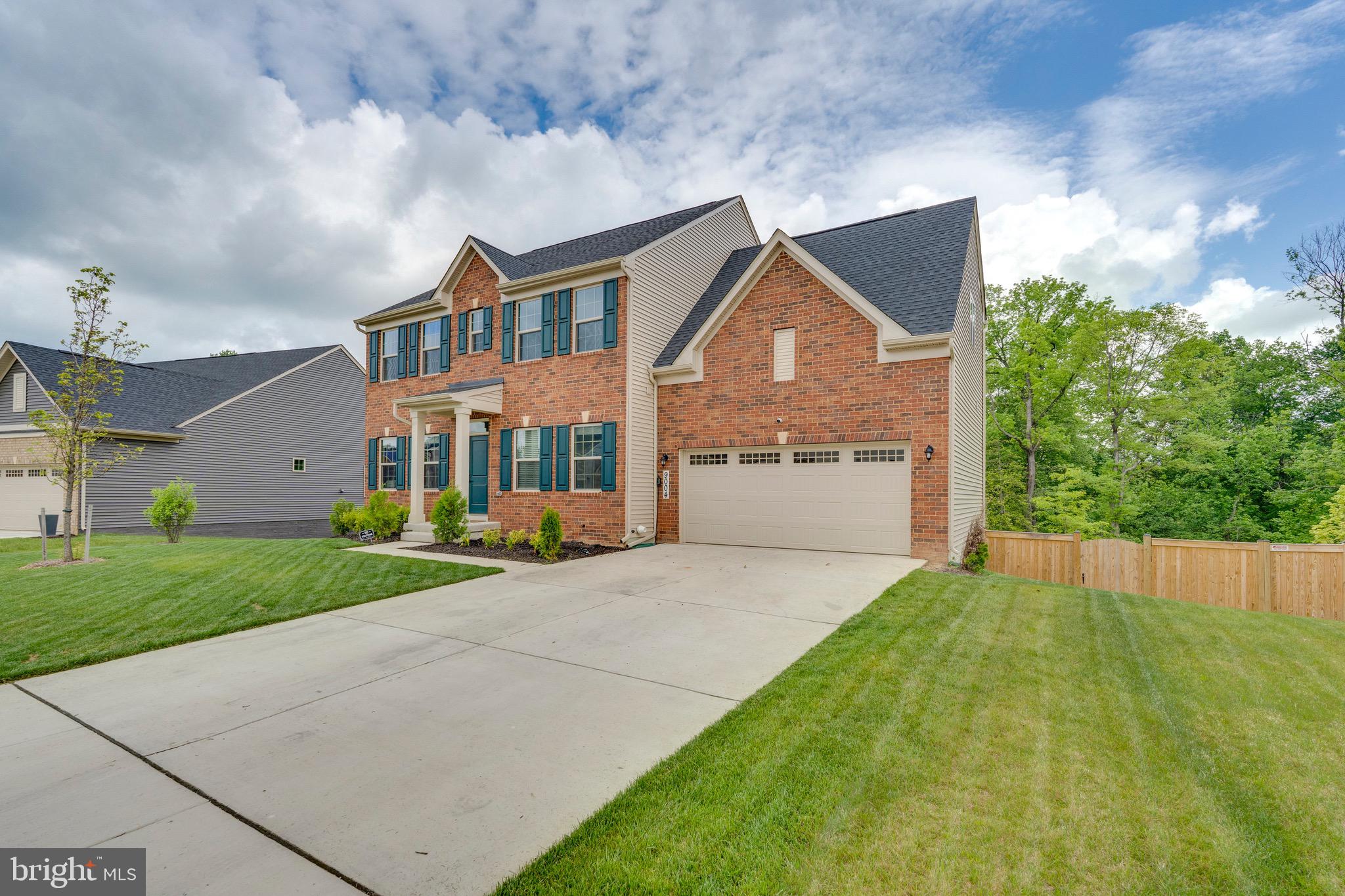 9004 Cavesson Way Upper Marlboro, MD 20772 - Photo 3 of 60 a front view of a house with a yard and garage