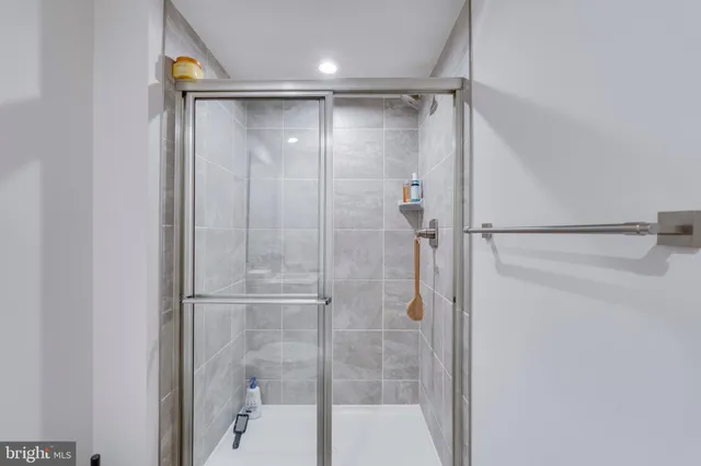 a large white kitchen with stainless steel appliances lots of white cabinets