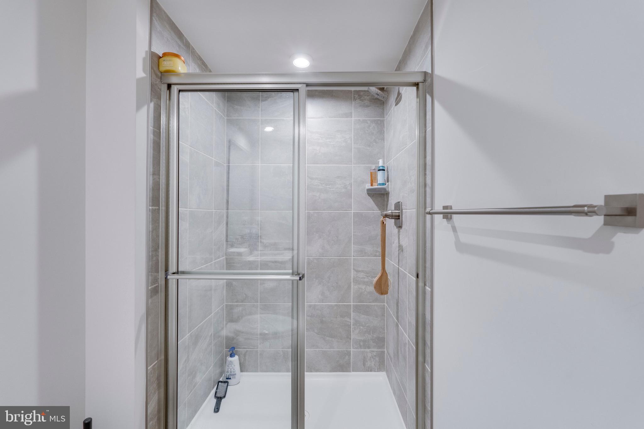 9004 Cavesson Way Upper Marlboro, MD 20772 - Photo 34 of 60 a bathroom with a glass shower door