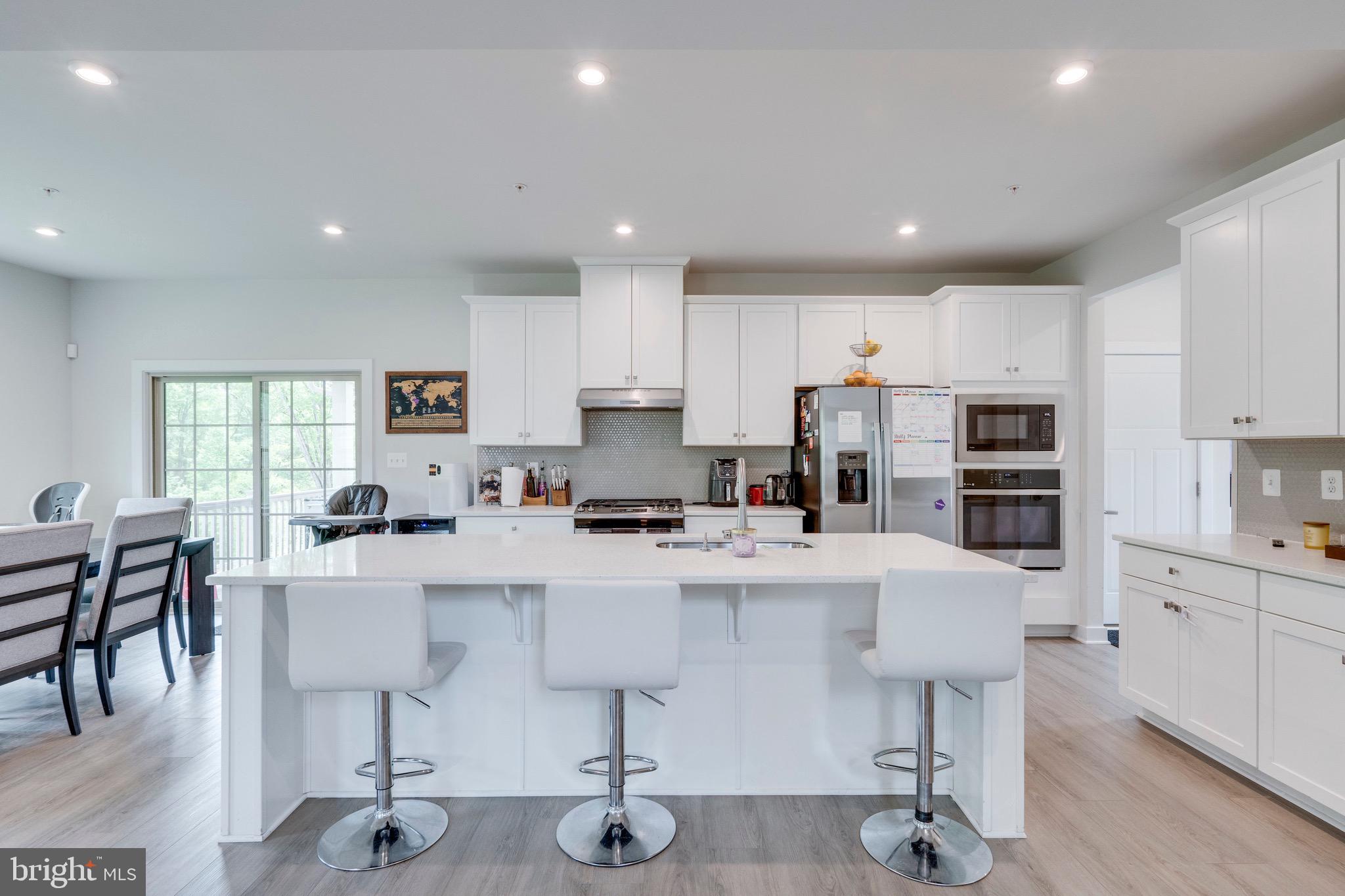 9004 Cavesson Way Upper Marlboro, MD 20772 - Photo 40 of 60 a large white kitchen with stainless steel appliances lots of white cabinets
