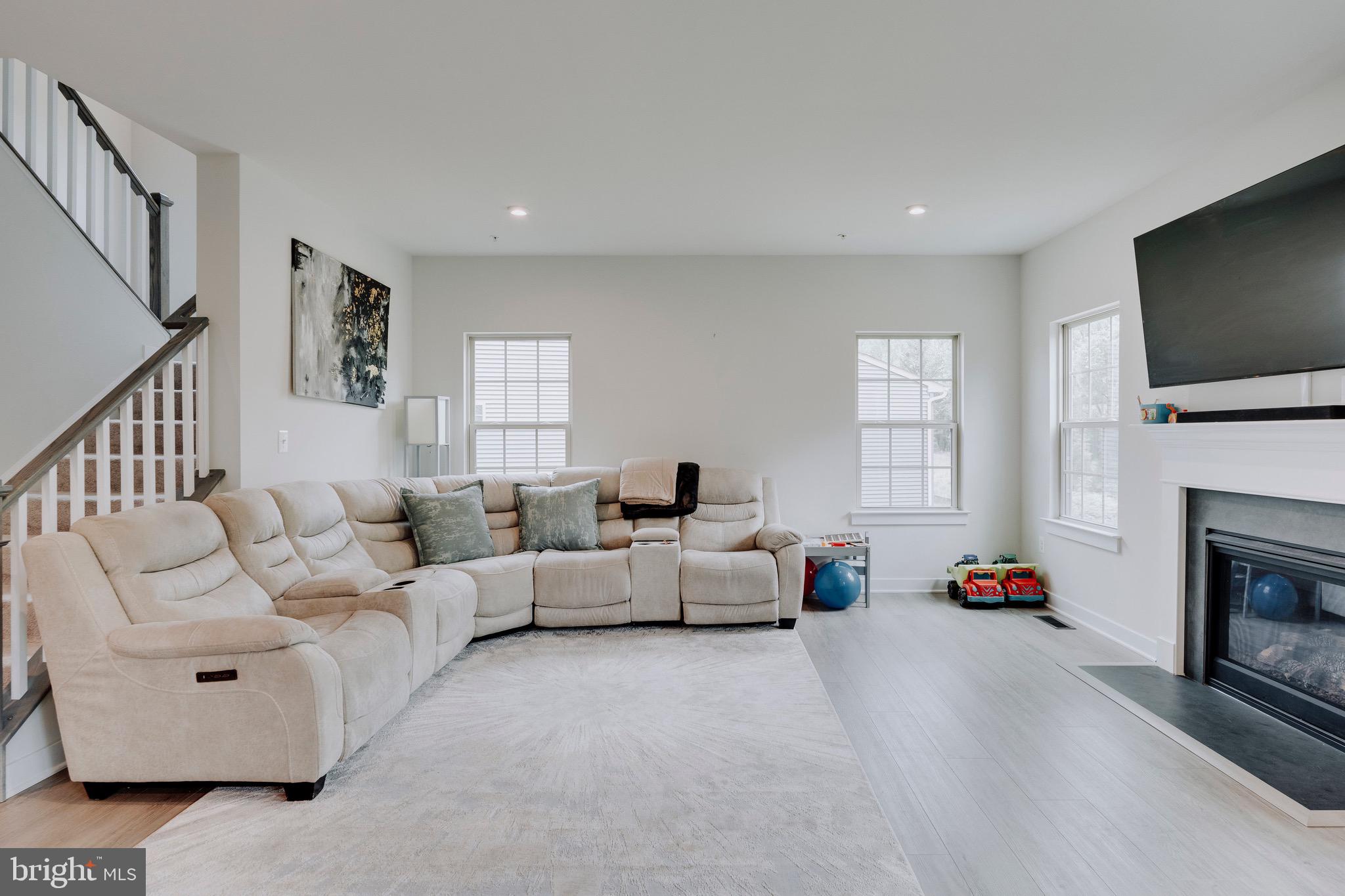 9004 Cavesson Way Upper Marlboro, MD 20772 - Photo 52 of 60 a living room with fireplace furniture and a flat screen tv