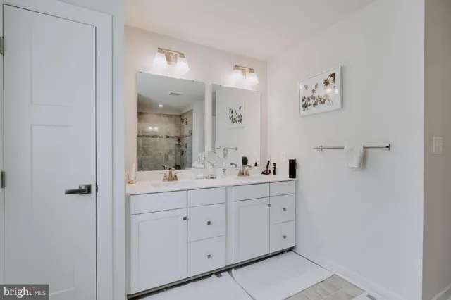 a view of walk in closet with clothes