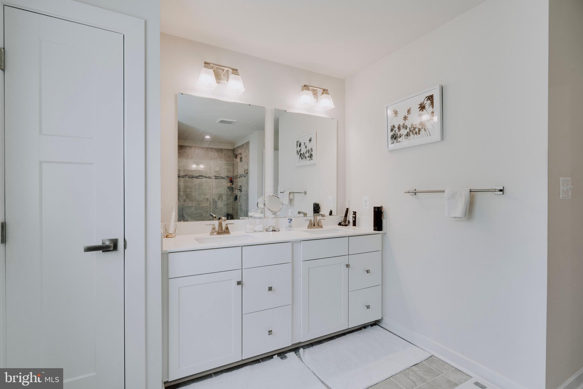 9004 Cavesson Way Upper Marlboro, MD 20772 - Photo 6 of 60 a bathroom with a double vanity sink a mirror and shower