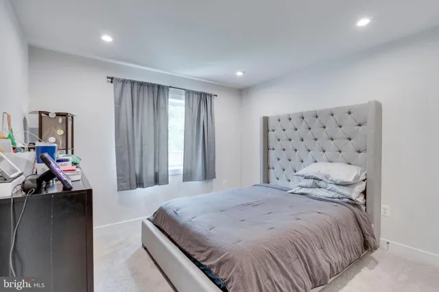 a spacious bedroom with a bed and a large window