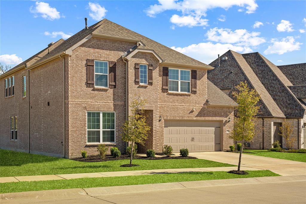9517 Sunset Lane Oak Point, TX 75068 - Photo 3 of 40 9517 Sunset Lane, Oak Point, TX 75068 - front of home - View of front of property with brick siding, a garage, concrete driveway, and a shingled roof