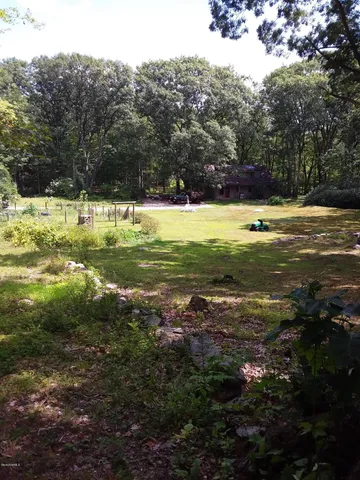a view of yard with swimming pool and green space