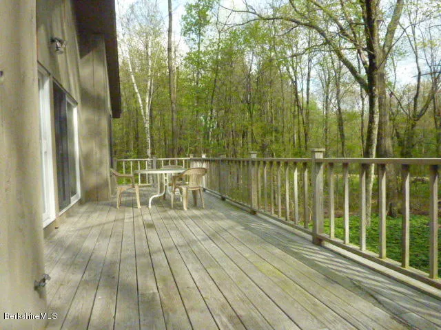 a view of balcony with wooden floor and fence
