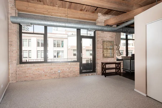 a view of empty room with air conditioner and furniture