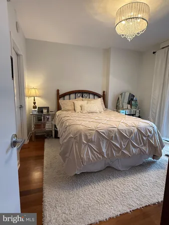 a bedroom with a bed and a chandelier