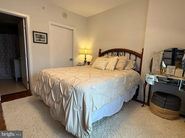 a bedroom with a bed and a tv