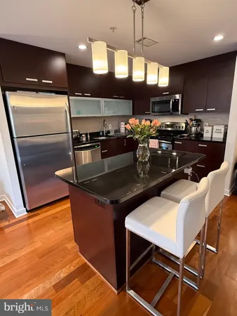 a kitchen with stainless steel appliances granite countertop a stove a refrigerator and a microwave