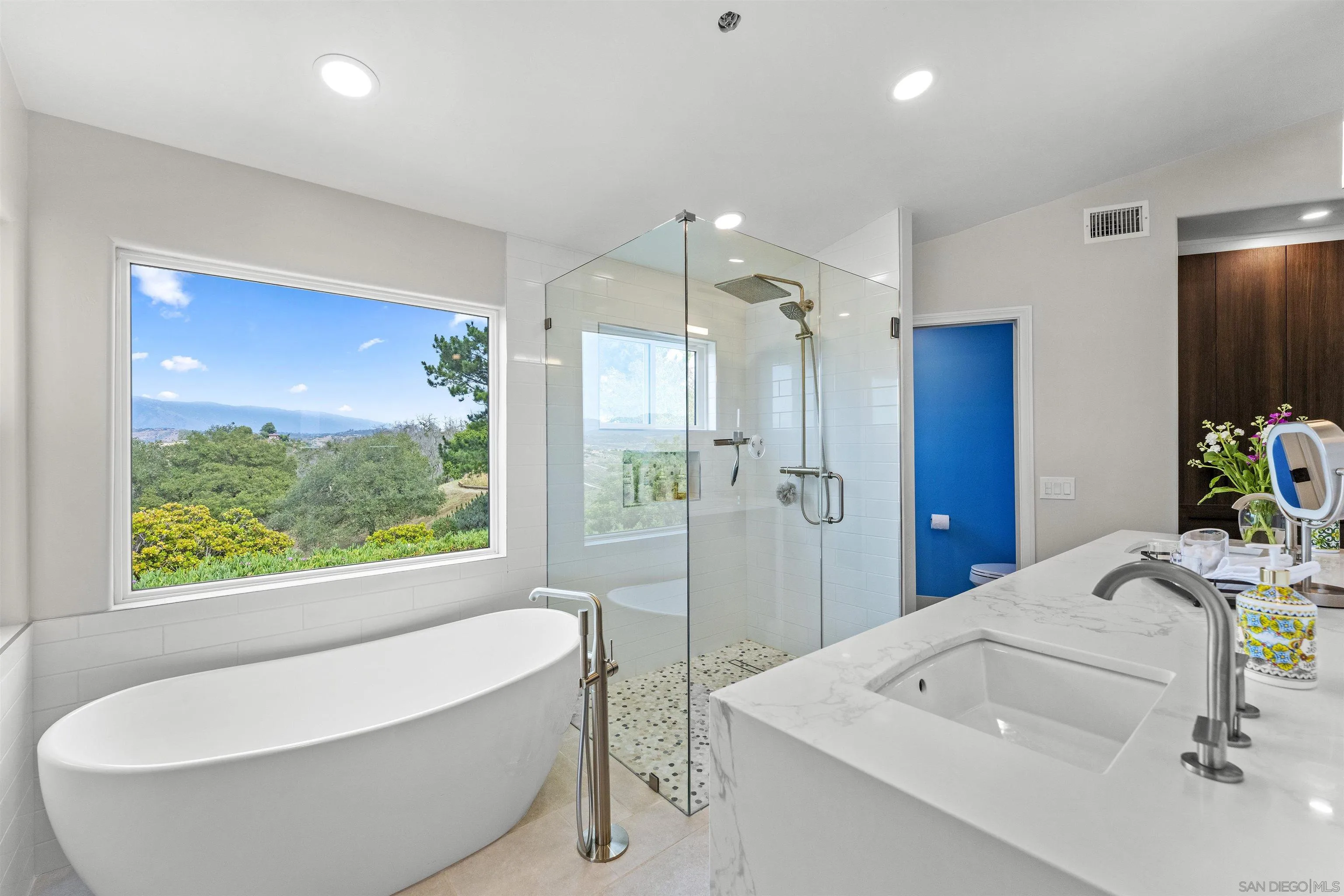 30659 Diaz Road Valley Center, CA 92082 - Photo 6 of 44 a bathroom with a tub a sink and a large window