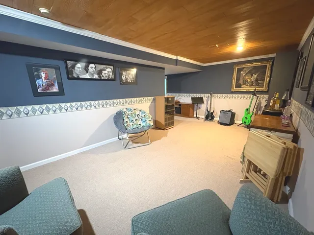 a view of a livingroom with furniture and a flat screen tv