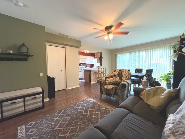 a living room with furniture a chandelier and a window