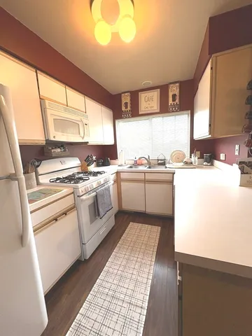 a kitchen with a stove a sink and a window