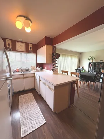 a kitchen with a sink appliances and cabinets