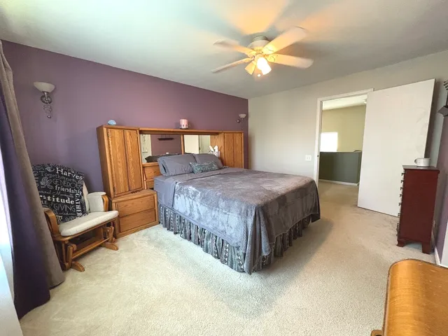a bedroom with a bed a couch and dresser
