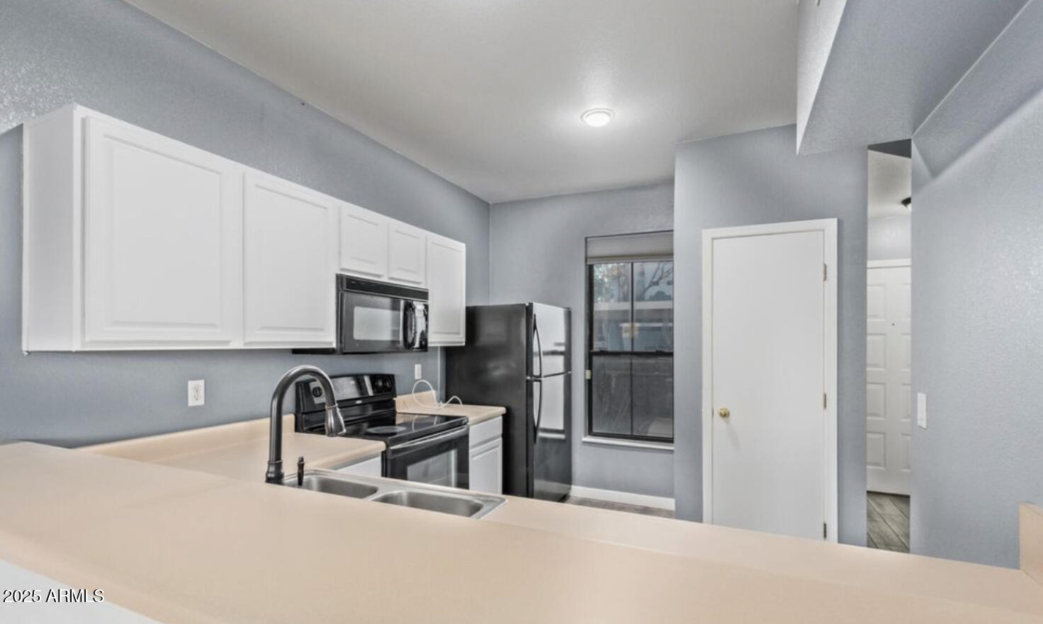 280 South Elizabeth Way, Unit 14 Chandler, AZ 85225 - Photo 13 of 26 a kitchen with stainless steel appliances a refrigerator and a stove top oven