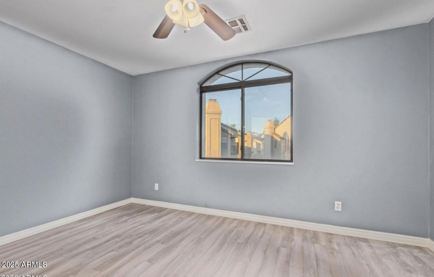280 South Elizabeth Way, Unit 14 Chandler, AZ 85225 - Photo 15 of 26 an empty room with wooden floor and windows