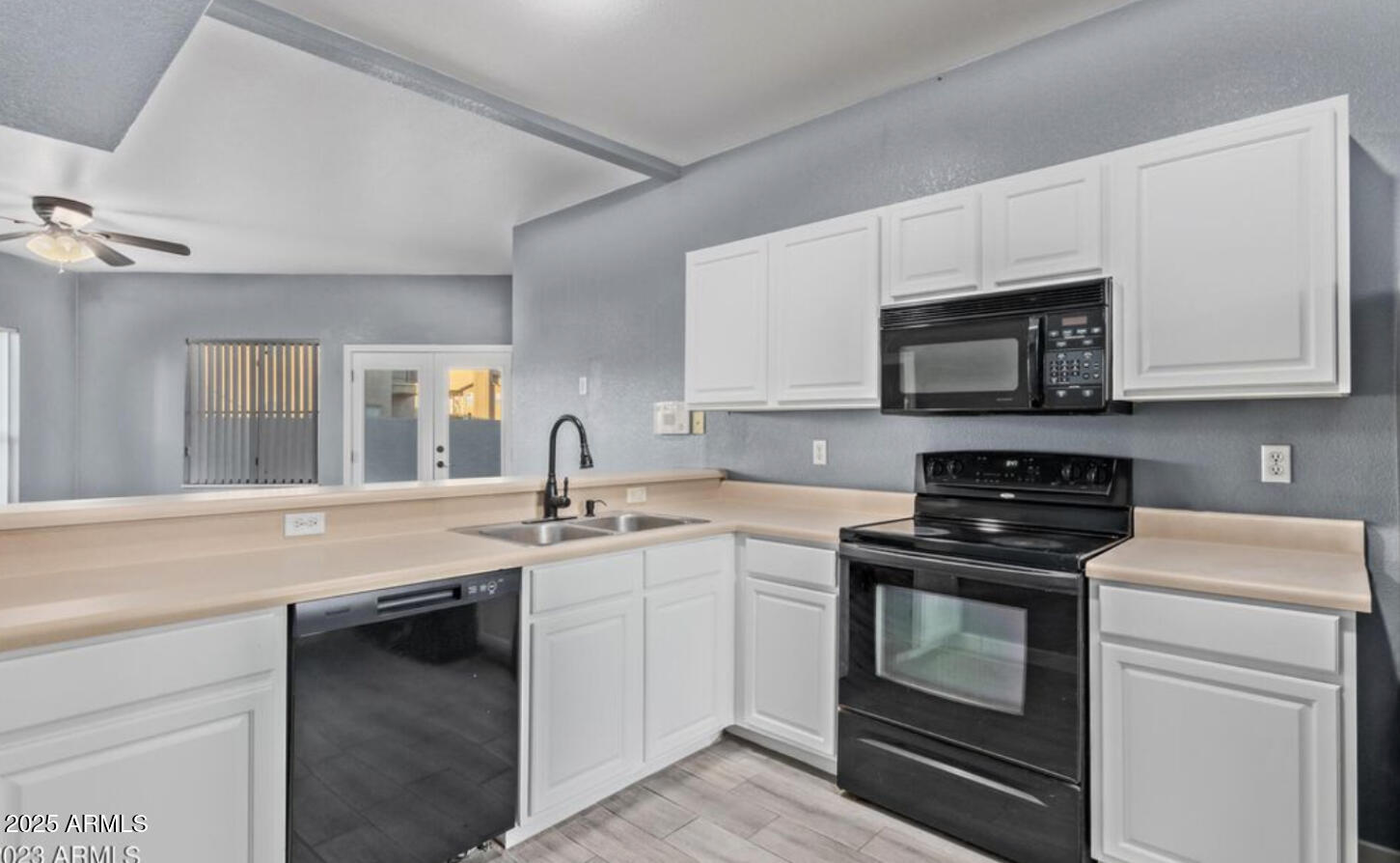 280 South Elizabeth Way, Unit 14 Chandler, AZ 85225 - Photo 20 of 26 a kitchen with stainless steel appliances granite countertop a sink stove and microwave