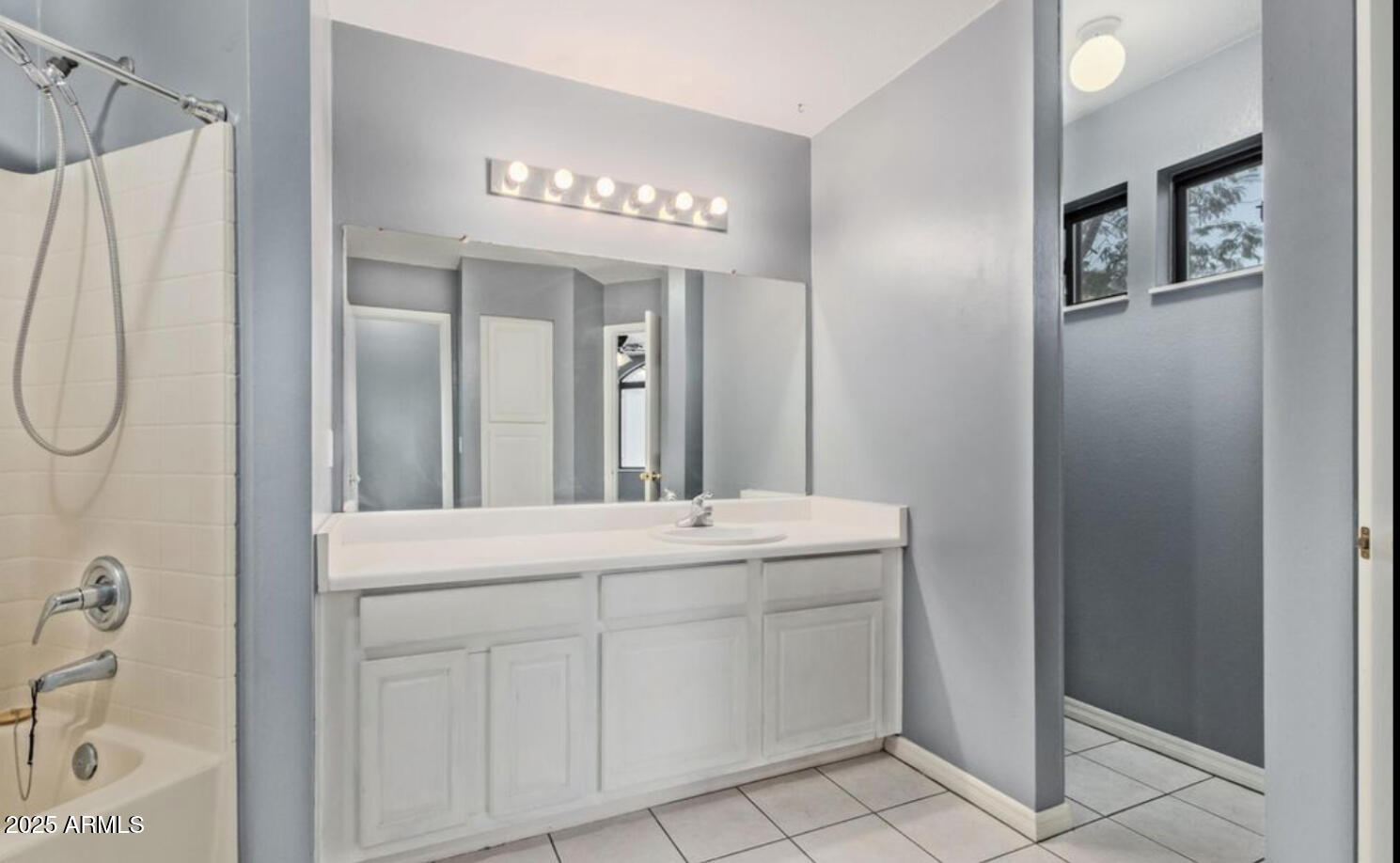 280 South Elizabeth Way, Unit 14 Chandler, AZ 85225 - Photo 9 of 26 a bathroom with a sink a mirror and a shower