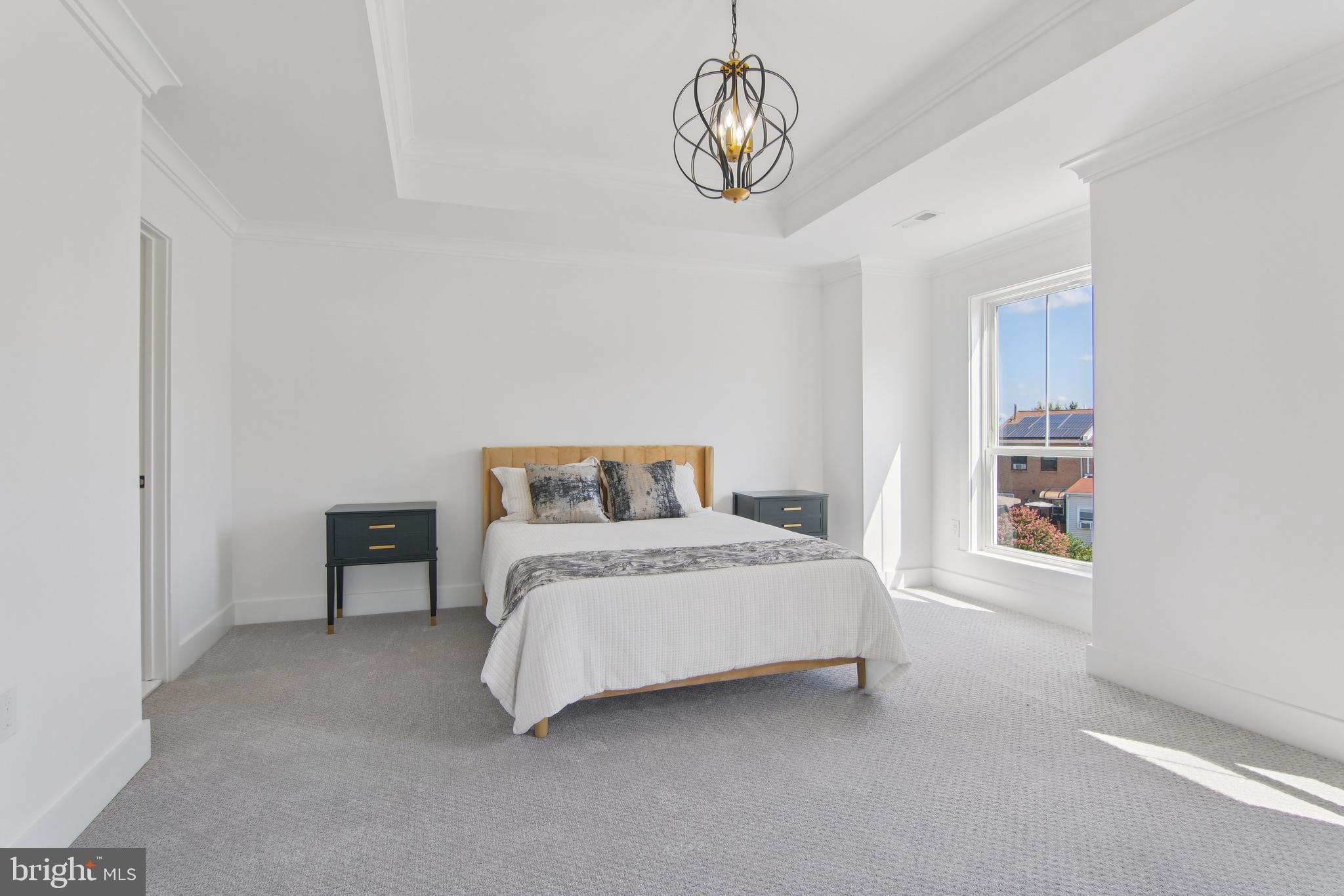 9838 Legion Street, Unit 3 Philadelphia, PA 19114 - Photo 38 of 51 a spacious bedroom with a bed and a large window