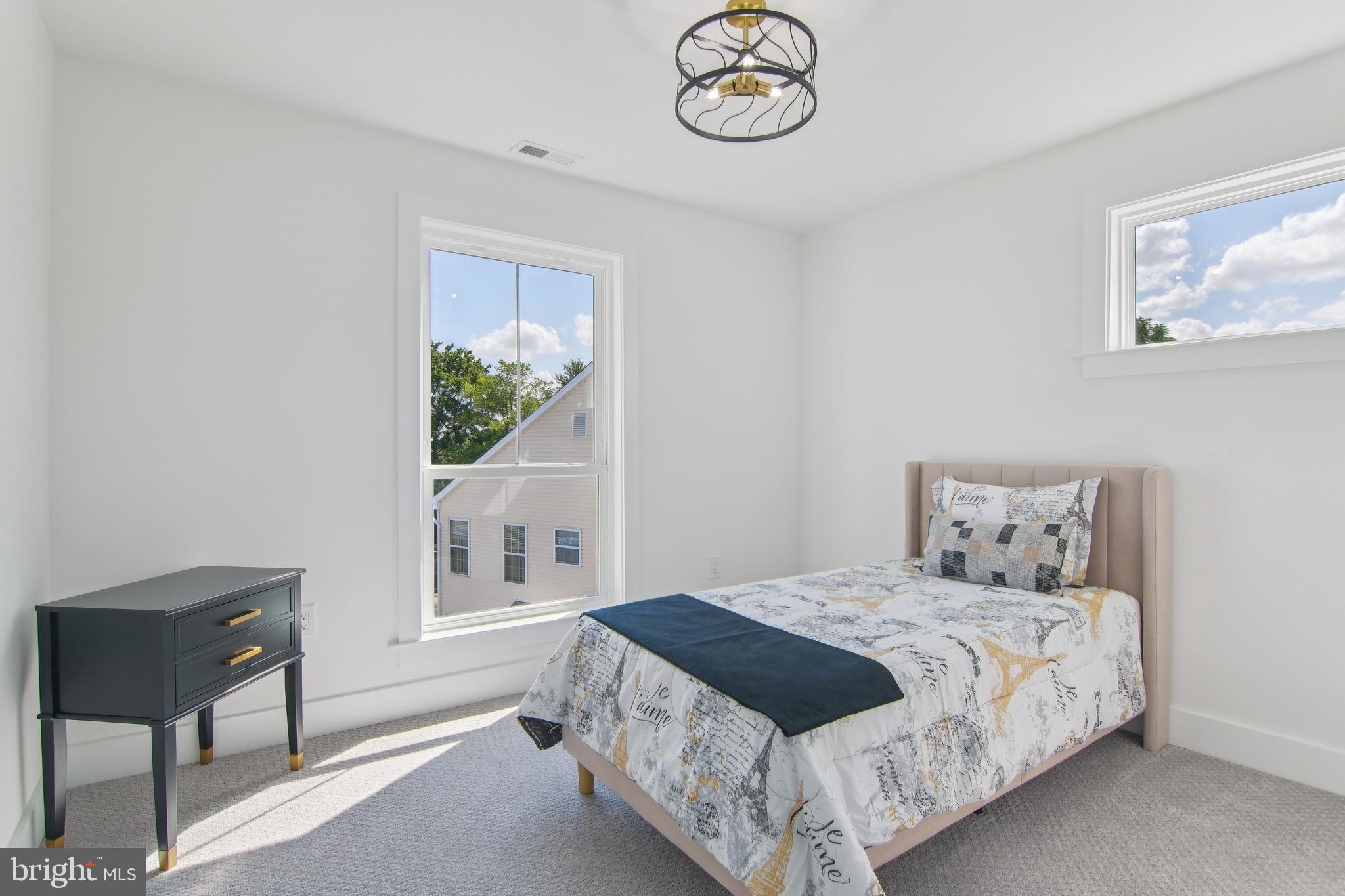 9838 Legion Street, Unit 3 Philadelphia, PA 19114 - Photo 42 of 51 a bedroom with a bed and a window