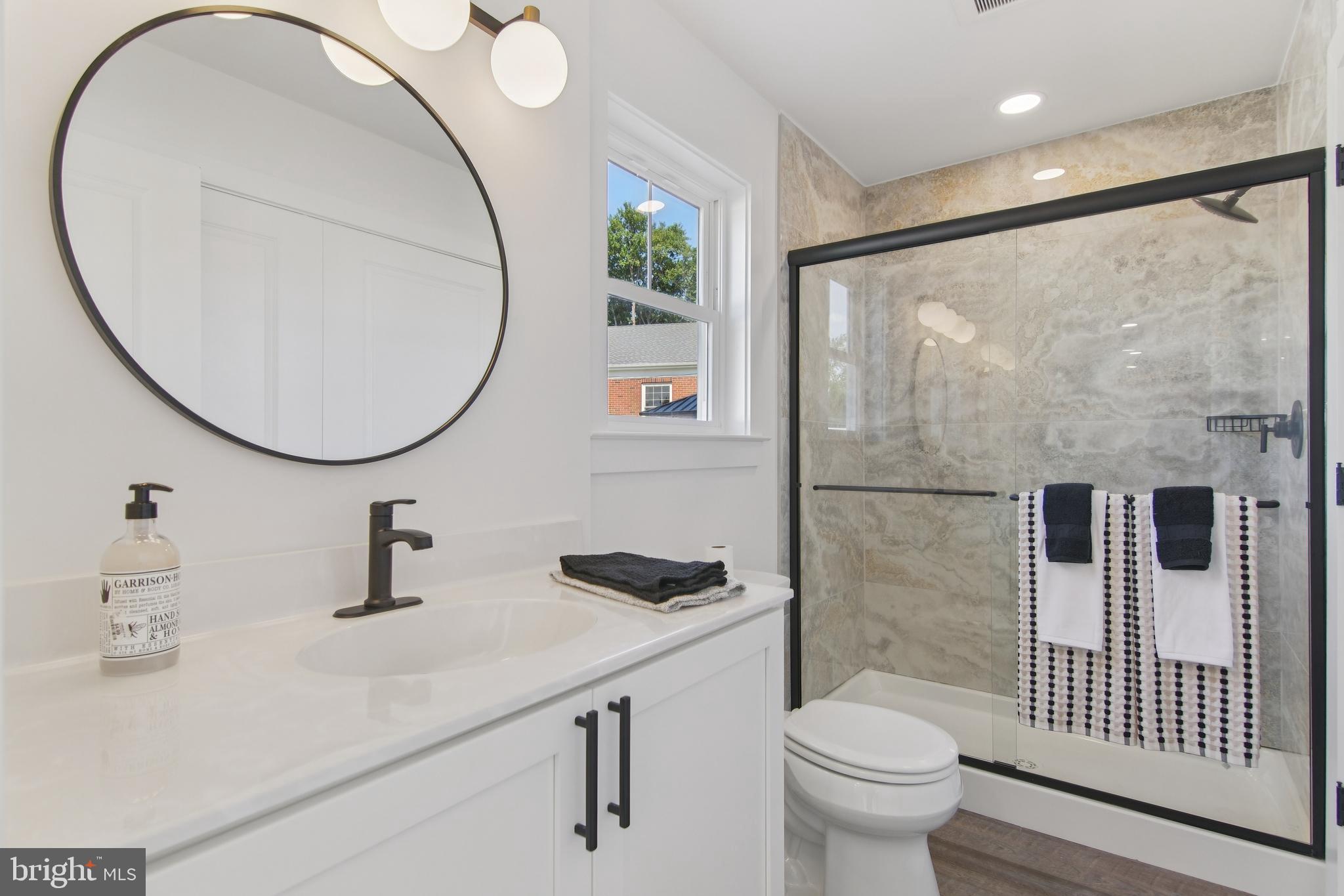 9838 Legion Street, Unit 3 Philadelphia, PA 19114 - Photo 47 of 51 a bathroom with a sink a toilet and a mirror