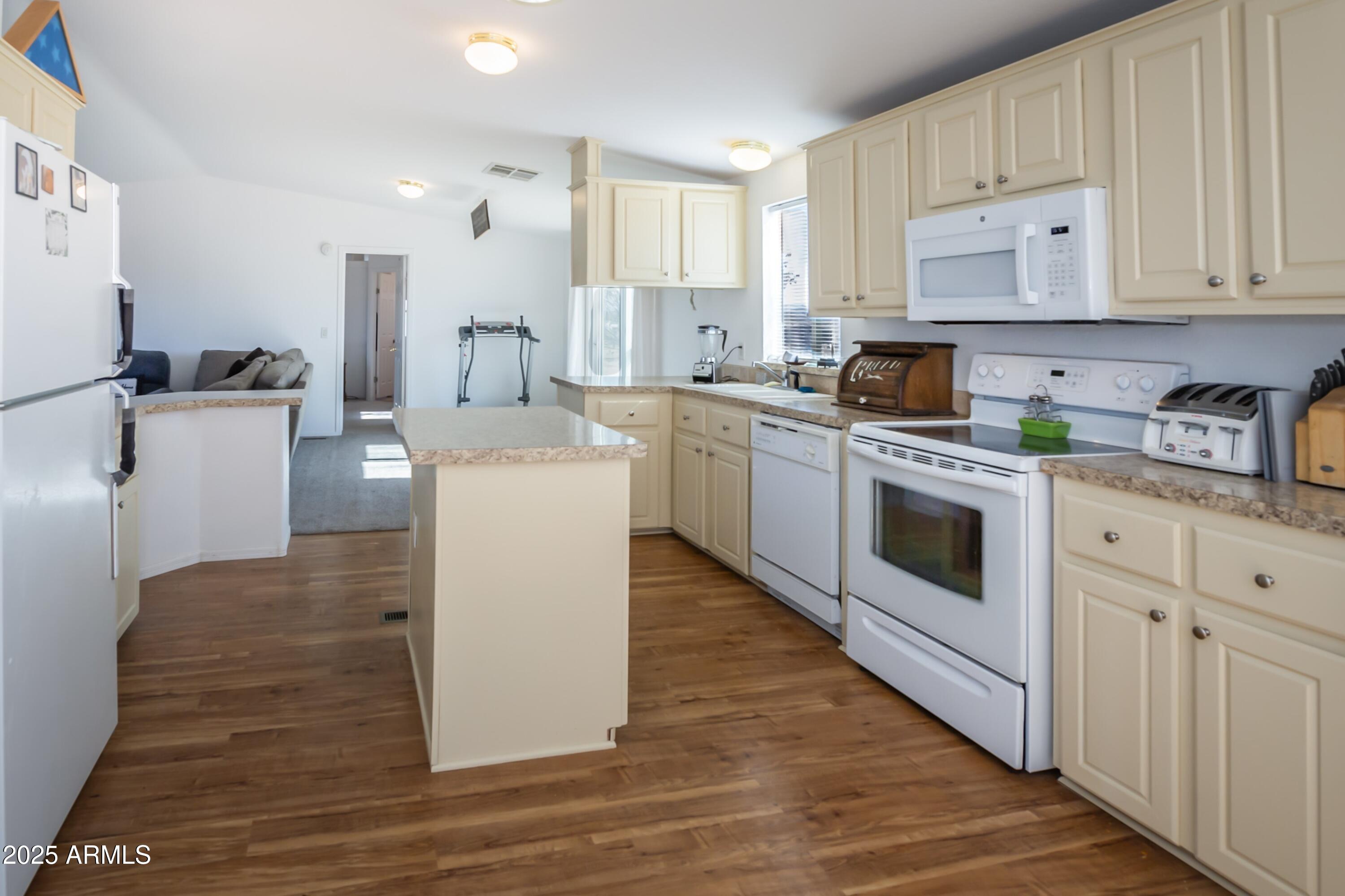 255 West Antelope Run Road Paulden, AZ 86334 - Photo 9 of 26 a kitchen with white cabinets and white appliances