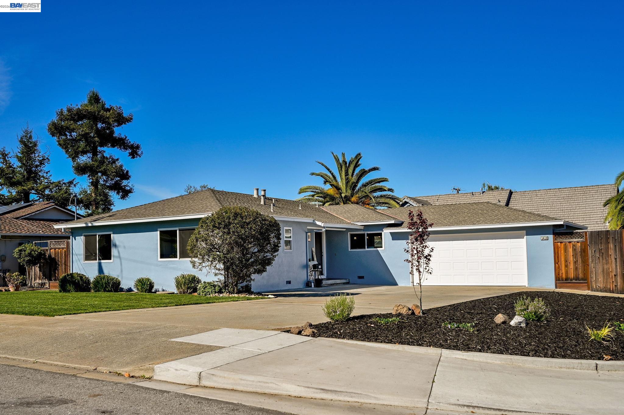 1416 Harrington Street Fremont, CA 94539 - Photo 1 of 1 a front view of a house with a yard and garage