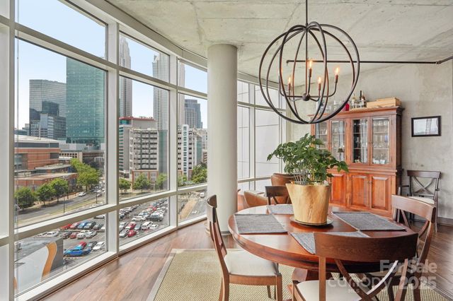 a dining room with wooden floor a glass table and chairs